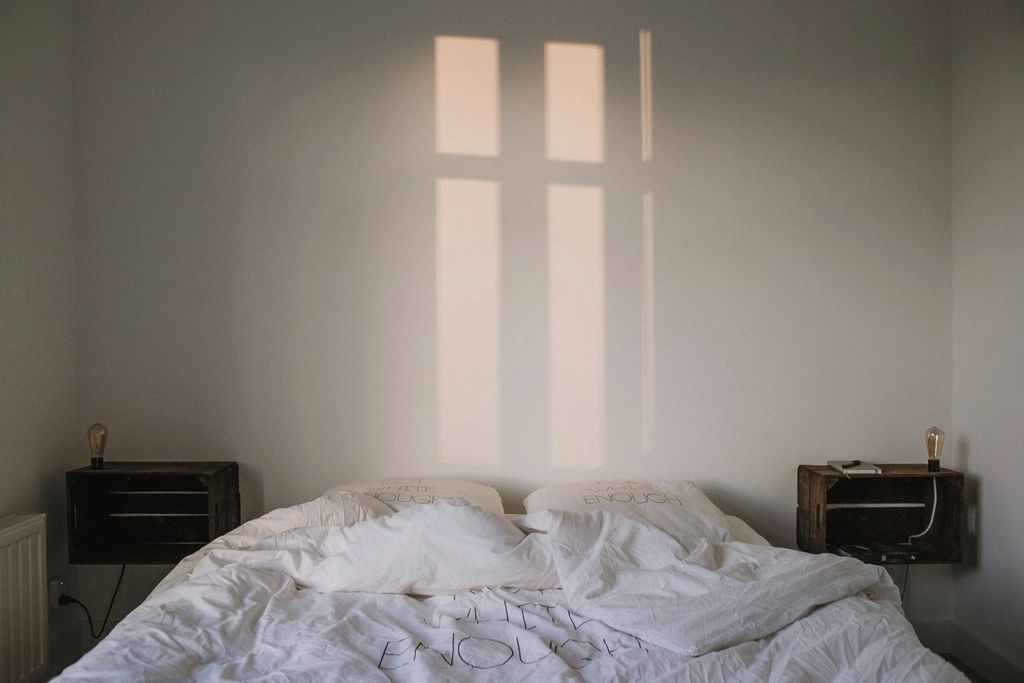 A guest room with two beds and a window